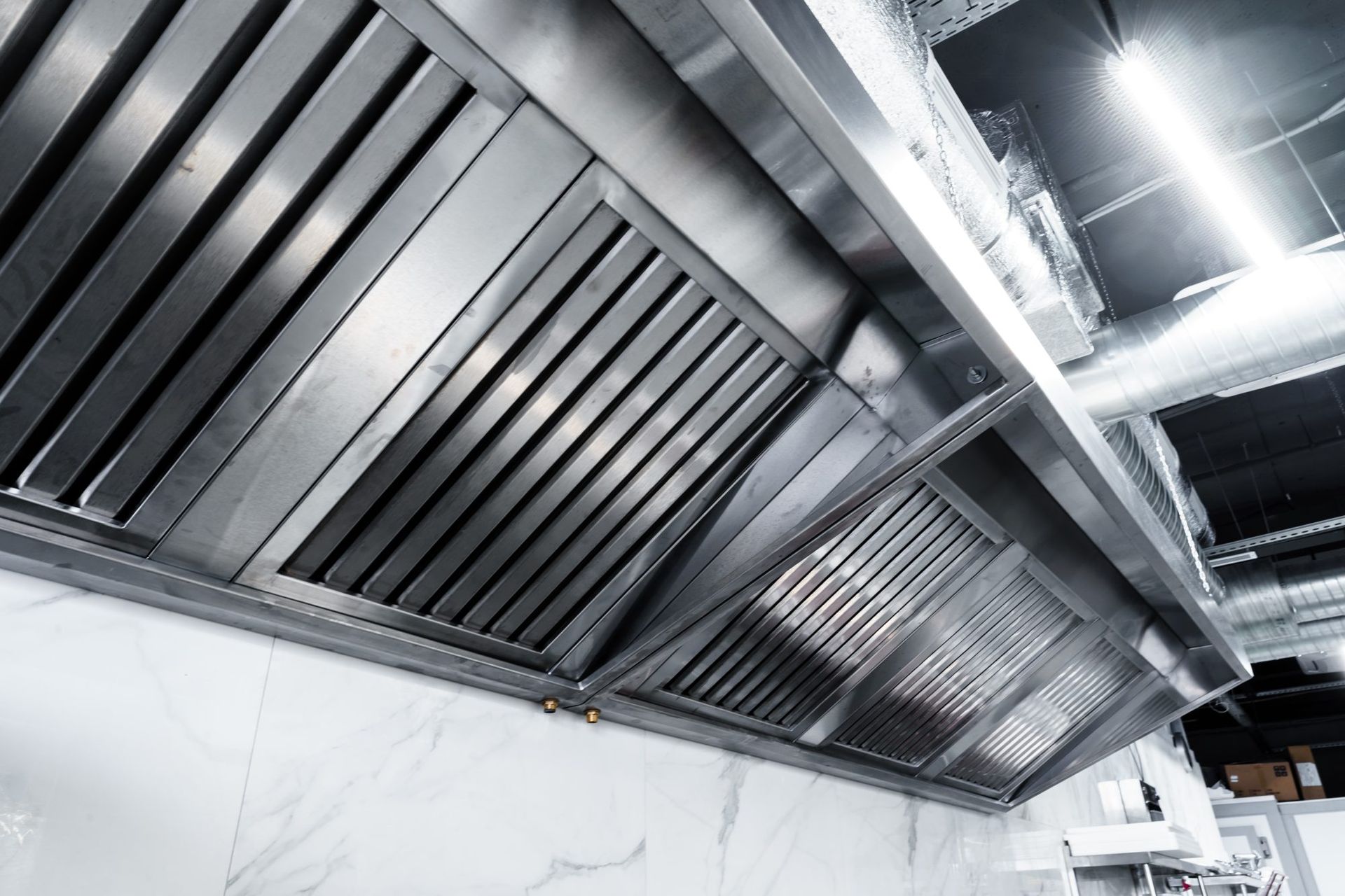 Clean commercial kitchen exhaust hood after professional service